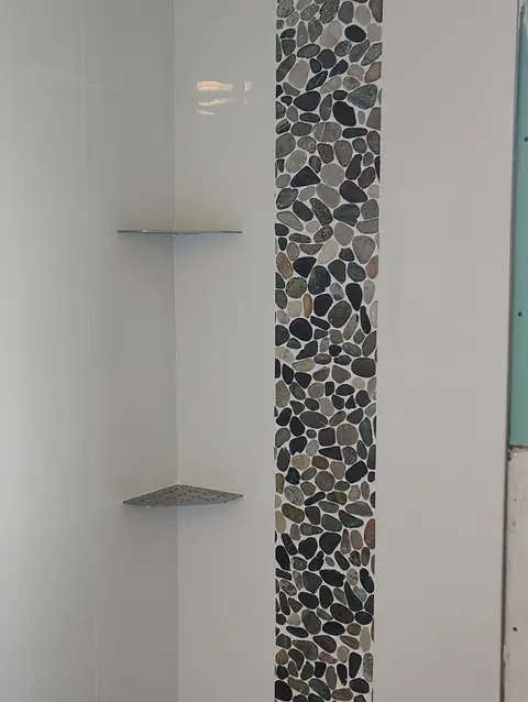 Pebble mosaic accent strip with corner shelves, real Bellagio Tile & Flooring work photo 18