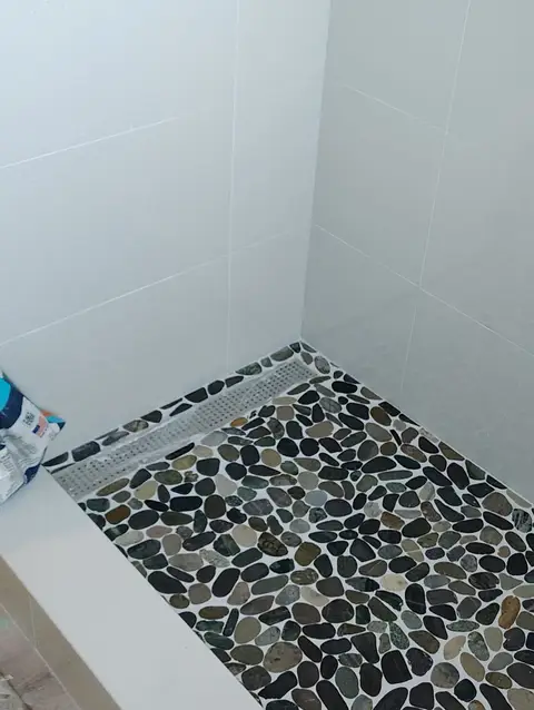 Pebble mosaic shower floor detail, real Bellagio Tile & Flooring work photo 19